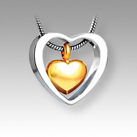 open silver heart with separate gold heart inside pendant