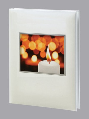 Glowing white candle with multiple candles in background funeral guest book