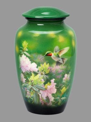 Hummingbird flying above flowers on green urn