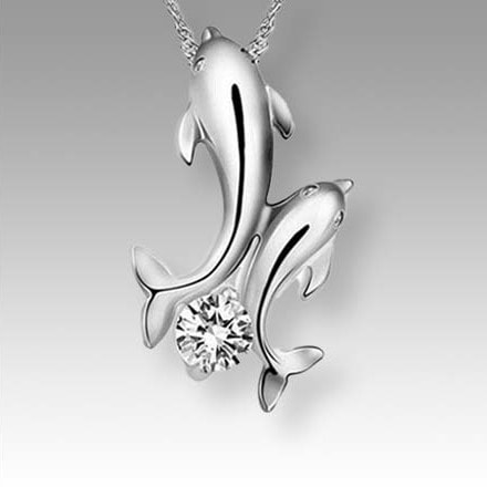 two silver dolphins with gem pendant